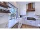 Modern kitchen with white cabinets, marble counters, and farm sink at 7257 E Visao Dr, Scottsdale, AZ 85266