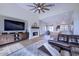 Open living room showcasing a fireplace, hardwood floors, and a view into the kitchen at 7257 E Visao Dr, Scottsdale, AZ 85266