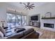 Relaxing living room featuring a fireplace, large TV, and access to the backyard pool at 7257 E Visao Dr, Scottsdale, AZ 85266