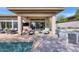 Covered patio with outdoor kitchen, seating, and sliding glass doors at 7257 E Visao Dr, Scottsdale, AZ 85266