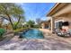 Resort-style pool with spacious patio, water features, and outdoor seating at 7257 E Visao Dr, Scottsdale, AZ 85266