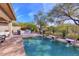 Inviting pool and spa with a stone patio and lush landscaping at 7257 E Visao Dr, Scottsdale, AZ 85266