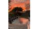 Stunning sunset view over a tranquil backyard pool and water features at 7257 E Visao Dr, Scottsdale, AZ 85266