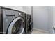 Close-up view of front load washer and dryer set on light tile floor at 730 E Zesta Ln # 101, Gilbert, AZ 85297