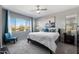 Bright main bedroom with large window, plush bed, and seating area at 730 E Zesta Ln # 101, Gilbert, AZ 85297