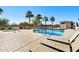 Community pool with spa, lounge chairs, and palm trees at 730 E Zesta Ln # 101, Gilbert, AZ 85297