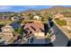 Aerial view of a house in a residential neighborhood with mountain views at 7920 E Sierra Morena E Cir, Mesa, AZ 85207