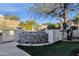 Landscaped backyard with stone retaining wall and lush greenery at 7920 E Sierra Morena E Cir, Mesa, AZ 85207