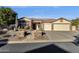 Single-story home with a two-car garage and landscaped front yard at 7920 E Sierra Morena E Cir, Mesa, AZ 85207