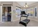 Bright home gym with large windows and a treadmill at 7920 E Sierra Morena E Cir, Mesa, AZ 85207