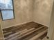 Small bedroom with wood-look floors and window blinds at 805 W Raymond St, Coolidge, AZ 85128