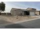 Tan colored house with a desert landscape and fire hydrant at 805 W Raymond St, Coolidge, AZ 85128