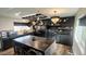 Modern kitchen with dark cabinetry, pot rack, and large island at 8149 W Daley Ln, Peoria, AZ 85383