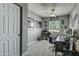 Functional home office with a ceiling fan, a comfortable chair, and a bright window at 8149 W Daley Ln, Peoria, AZ 85383