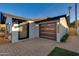 Modern home with a large garage and stylish entryway at 8235 E Glenrosa Ave, Scottsdale, AZ 85251