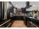 Modern kitchen with dark cabinetry and stainless steel appliances at 8235 E Glenrosa Ave, Scottsdale, AZ 85251