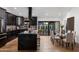 Modern kitchen with dark cabinetry, marble island, and breakfast bar at 8235 E Glenrosa Ave, Scottsdale, AZ 85251