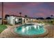 Stunning pool and spa with patio seating at twilight at 8235 E Glenrosa Ave, Scottsdale, AZ 85251