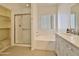 Main bathroom with soaking tub, shower, and updated vanity at 9561 W Debbie Pl, Arizona City, AZ 85123