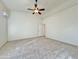 Spacious bedroom with ceiling fan and wall-to-wall carpet at 9561 W Debbie Pl, Arizona City, AZ 85123