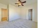 Well-lit bedroom featuring a ceiling fan and built-in closet at 9561 W Debbie Pl, Arizona City, AZ 85123