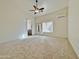 Bright and airy bedroom with ceiling fan and plush carpeting at 9561 W Debbie Pl, Arizona City, AZ 85123