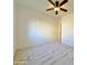 Spacious bedroom with ceiling fan and closet; neutral color palette at 9561 W Debbie Pl, Arizona City, AZ 85123