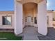 Front entrance with arched entryway and decorative screen door at 9561 W Debbie Pl, Arizona City, AZ 85123