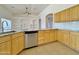 Kitchen with granite countertops, stainless steel dishwasher, and wood cabinets at 9561 W Debbie Pl, Arizona City, AZ 85123