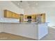 Kitchen island with granite countertop and stainless steel sink at 9561 W Debbie Pl, Arizona City, AZ 85123