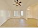 Living room with tile flooring, ceiling fan, and large window at 9561 W Debbie Pl, Arizona City, AZ 85123