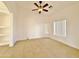 Living room with tile flooring, ceiling fan, and built-in shelving at 9561 W Debbie Pl, Arizona City, AZ 85123