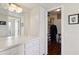 Bathroom vanity with white cabinets and a large mirror at 9729 W Pinecrest Dr, Sun City, AZ 85351