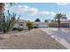 Desert landscaping with gravel, cactus, and palm trees in front of a home at 9729 W Pinecrest Dr, Sun City, AZ 85351