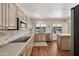 Modern kitchen with stainless steel appliances and a breakfast bar at 9729 W Pinecrest Dr, Sun City, AZ 85351