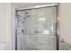 Updated shower with marble tile, glass enclosure, and modern fixtures at 9729 W Pinecrest Dr, Sun City, AZ 85351