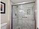 Modern shower with marble tile and glass enclosure at 9729 W Pinecrest Dr, Sun City, AZ 85351