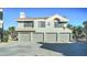 Front view of condo with three-car garage and desert landscaping at 10115 E Mountain View Rd # 2022, Scottsdale, AZ 85258