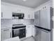 Modern kitchen with stainless steel appliances and white cabinets at 10115 E Mountain View Rd # 2022, Scottsdale, AZ 85258