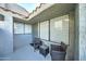 Small patio with two wicker chairs and a small table at 10115 E Mountain View Rd # 2022, Scottsdale, AZ 85258