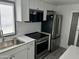 Close up of a bright kitchen featuring stainless steel appliances and a large window at 10951 N 91St Ave # 127, Peoria, AZ 85345