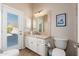 Clean bathroom with vanity, toilet, and exterior access at 12159 N 120Th Way, Scottsdale, AZ 85259