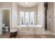 Elegant bathroom with soaking tub, walk-in shower, and large window at 12159 N 120Th Way, Scottsdale, AZ 85259
