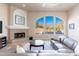 Living room with fireplace and large windows offering scenic views at 12159 N 120Th Way, Scottsdale, AZ 85259