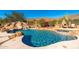 Resort-style backyard with a large pool, waterslide, and fire pit at 12159 N 120Th Way, Scottsdale, AZ 85259