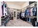 Ample walk-in closet with custom shelving and hanging rods at 12159 N 120Th Way, Scottsdale, AZ 85259