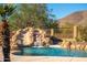 Relaxing waterfall feature flows into a refreshing pool at 12159 N 120Th Way, Scottsdale, AZ 85259