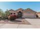 Single-story home with a two-car garage and well-manicured landscaping at 12701 W Avalon Dr, Avondale, AZ 85392