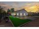 Backyard oasis with a lush faux grass patch, patio area, and privacy fencing perfect for outdoor enjoyment at 13022 W Surrey Ave, El Mirage, AZ 85335