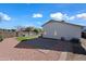 Backyard with gravel landscaping, green turf area, brick patio, and grill, ideal for outdoor living and entertaining at 13022 W Surrey Ave, El Mirage, AZ 85335